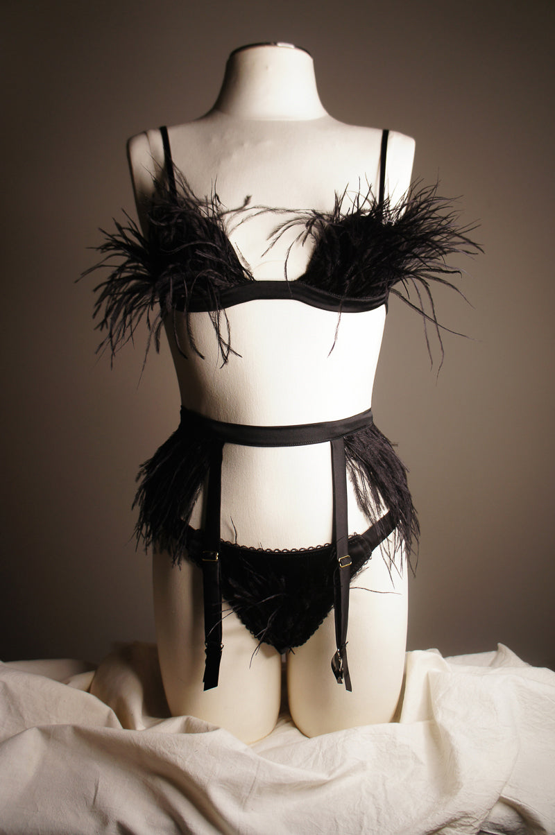 feather and silk lingerie set on mannequin