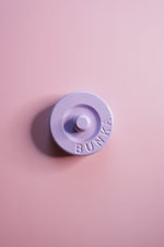 Purple fabric weight with 'BUNKA' branding on a pink background
